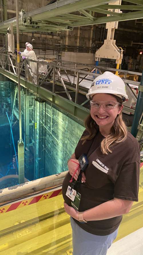 Lily Stuck stands in front of the spent fuel pool at Comanche Peak Nuclear Power Plant.